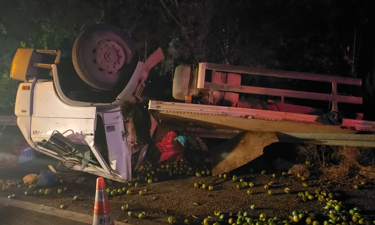 Caminhão carregado laranjas capota após bater em carreta duas