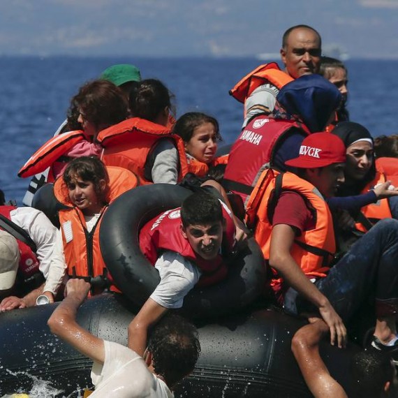 Syrian and Afghan refugees are seen on and around a dinghy that deflated some 100m away before reaching the Greek island of Lesbos, September 13, 2015. Of the record total of 432,761 refugees and migrants making the perilous journey across the Mediterranean to Europe so far this year, an estimated 309,000 people had arrived by sea in Greece, the International Organization for Migration (IMO) said on Friday. About half of those crossing the Mediterranean are Syrians fleeing civil war, according to the United Nations refugee agency. REUTERS/Alkis Konstantinidis