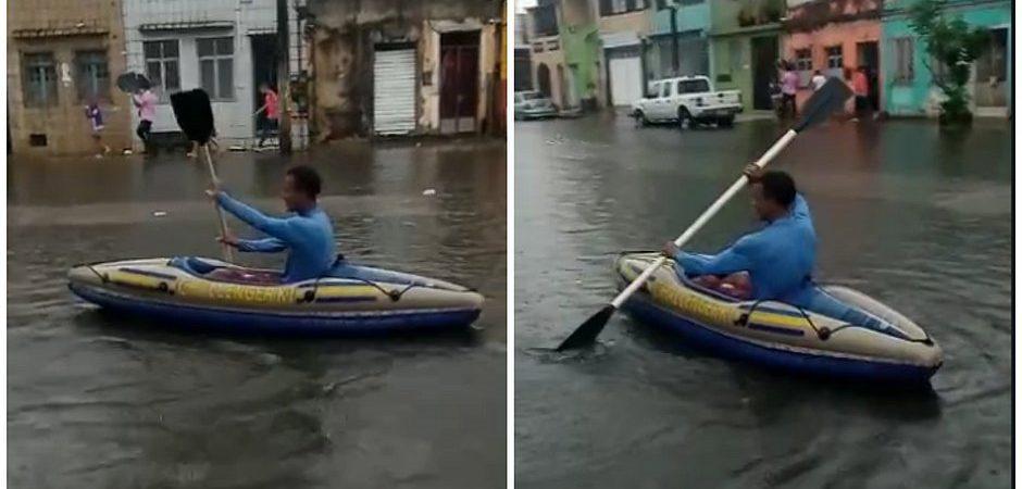 Morador usa barco para se locomover em rua alagada da Cidade Baixa